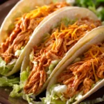 Close-up of Buffalo Chicken Tacos with vibrant toppings and a clean background.