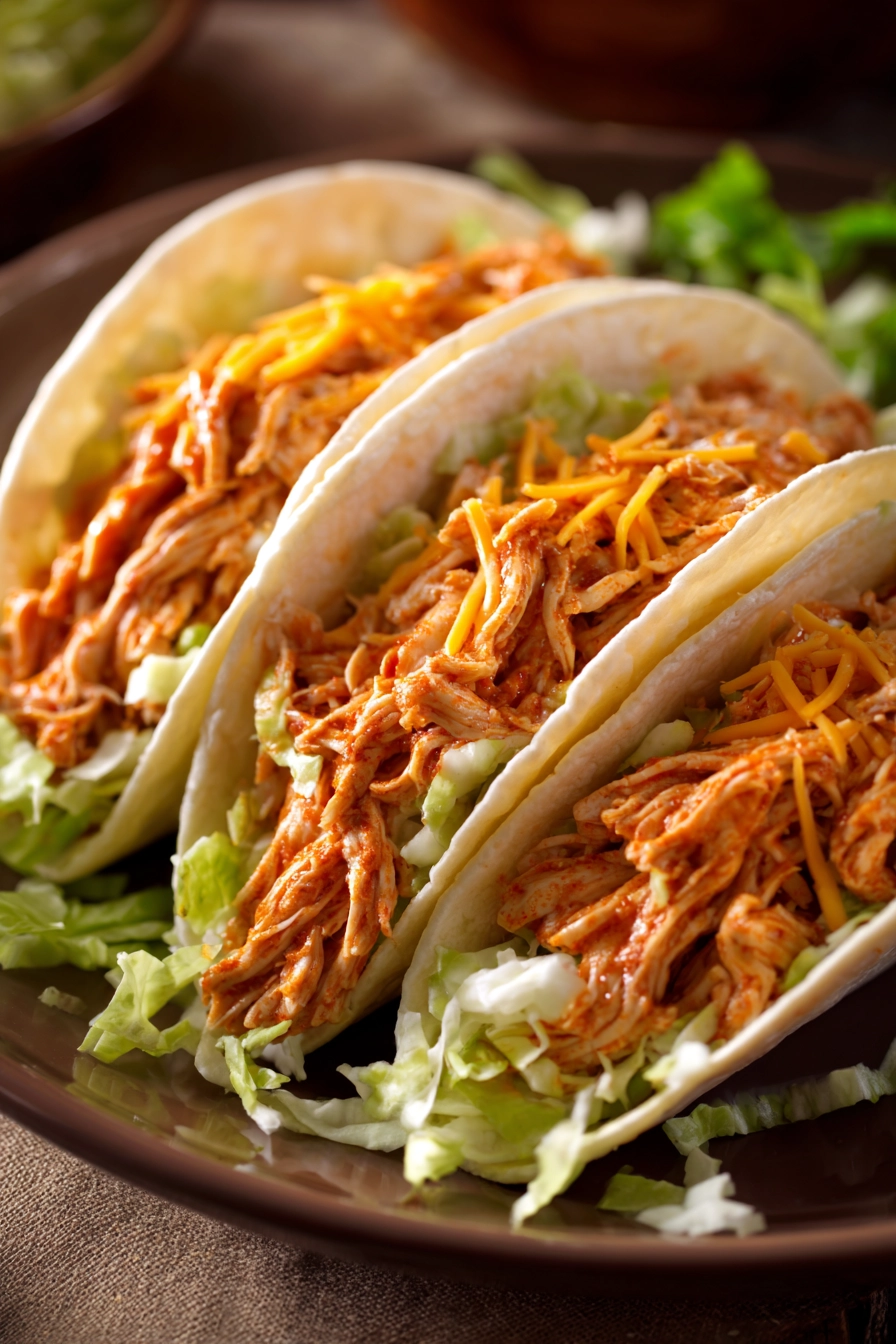 Close-up of Buffalo Chicken Tacos with vibrant toppings and a clean background.